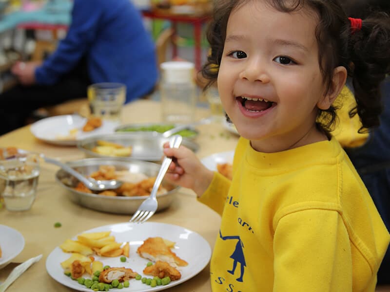 A young child at The Little Learners Montessori enjoying a nutritious meal, reflecting the nursery's commitment to providing healthy, balanced meals that support children’s growth and development in a joyful and engaging environment.