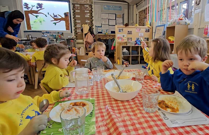 Children at The Little Learners Montessori enjoying a meal together at a table, fostering social interaction and healthy eating habits